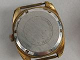 a close up of a watch on a table with a white background