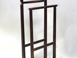 a wooden coat rack with a coat hanger on it
