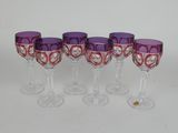 four purple wine glasses with hearts on them sitting on a table