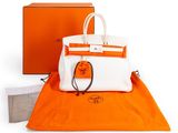 a white and orange bag sitting on top of an orange blanket
