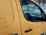 a yellow van that is parked in a garage
