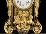 a gold clock that is sitting on top of a table