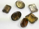 a group of five different colored stones on a white surface