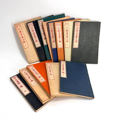 several books are stacked on top of each other on a white surface