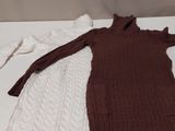 two sweaters on a table next to a pair of scissors