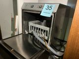 a dishwasher with a basket in the middle of it