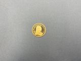 une pièce d'or sur laquelle est représentée la tête d'un homme