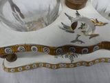 a glass bowl with a bird on it and a glass bowl with a bird on it