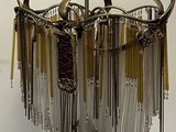 a chandelier hanging from the ceiling with a lot of beads hanging from it