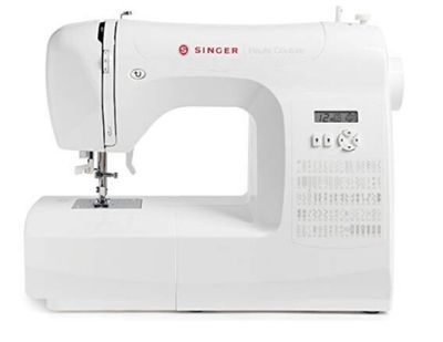 the white sewing machine is sitting on a white surface