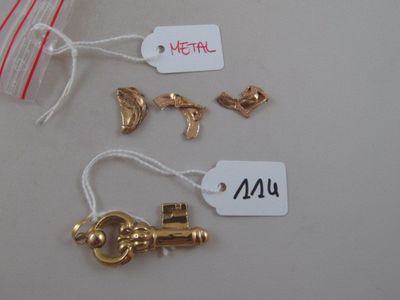 a lot of gold charms and tags on a table