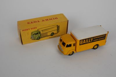 yellow and white toy truck and box on a white surface