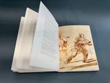 an open book with a drawing on it on a table