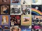 many different album covers on the wall of this room