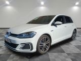 Une Volkswagen Golf blanche est garée sur un sol à damier.