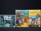 several board games are lined up on a black surface