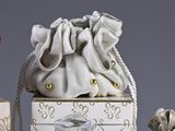 a small bag with a drawstring on it next to other items