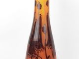 a glass vase that is sitting on a wooden stand