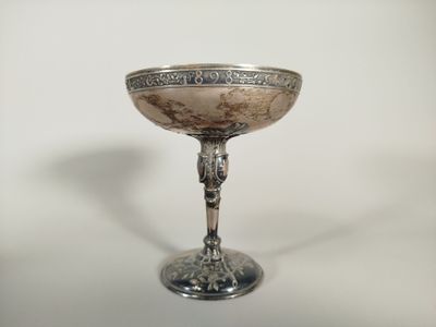 a silver cup that is sitting on a table