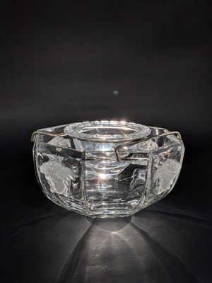 an image of a clear glass ashtray on a black background