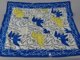 a close up of a blue and yellow scarf on a table