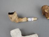 a pipe and a pipe holder sitting on a table