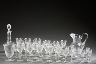 a lot of wine glasses and a pitcher on the table