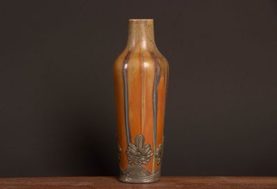 a vase that is sitting on a table with a black background