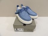 someone is wearing a pair of blue and white shoes on top of a box