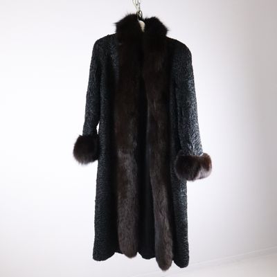 an image of a coat with a fur collar on a hanger