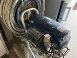 a hose that is attached to a wall next to a machine