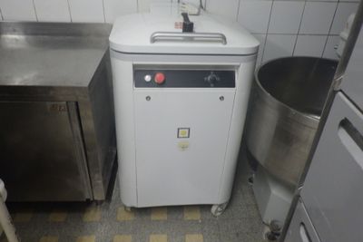 an image of a small kitchen with a washing machine in the corner