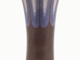 a blue and brown vase sitting on a white surface