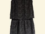 a black dress on a hanger on a white background