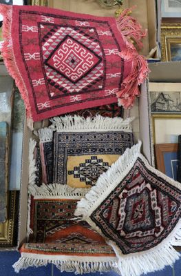 many rugs that are on a shelf in a room