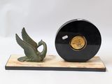 a clock and a bird on a stand on a white background