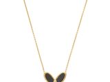 a black and gold butterfly necklace on a gold chain