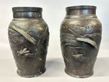 two vases that are sitting next to each other on a table