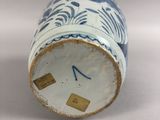 a blue and white vase sitting on a white surface