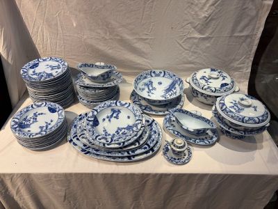 a lot of blue and white plates and bowls on a table