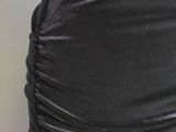 the skirt is black and has a ruched design on it