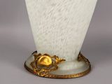 a white vase with a gold decoration on it