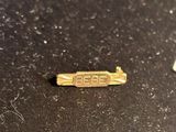 a small piece of gold on a black surface