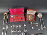 a box of silverware on a table next to a box of spoons