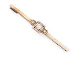 une broche en forme de barre, en or et diamants