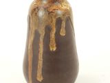 a brown vase with a drip of brown paint on it