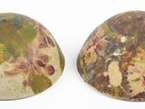two pieces of stone with different colors on them on a white surface