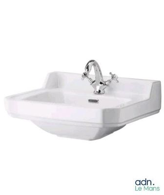 a white bathroom sink with a chrome faucet on it