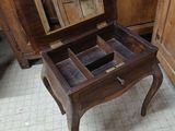 a small wooden table with a mirror on top of it