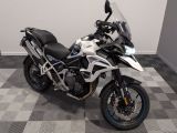 a motorcycle that is parked on a checkered floor